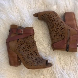 Vince Camuto cut out peep toe zipper booties.